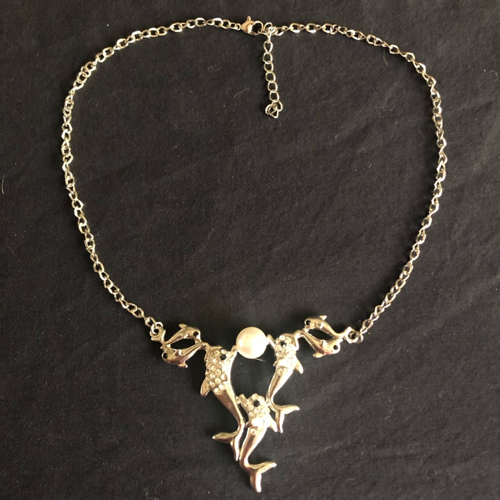 Silver tone playful dolphins necklace